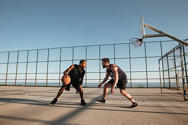 Two men playing basketball. 